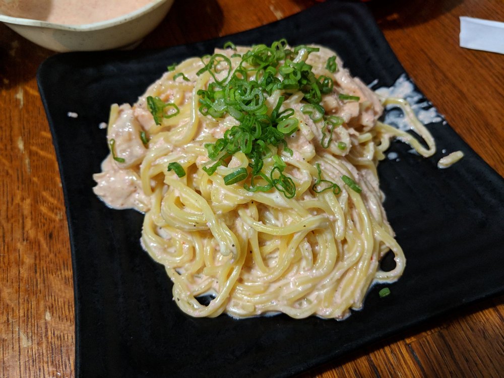 Spaghetti in a creamy sauce topped with green onion