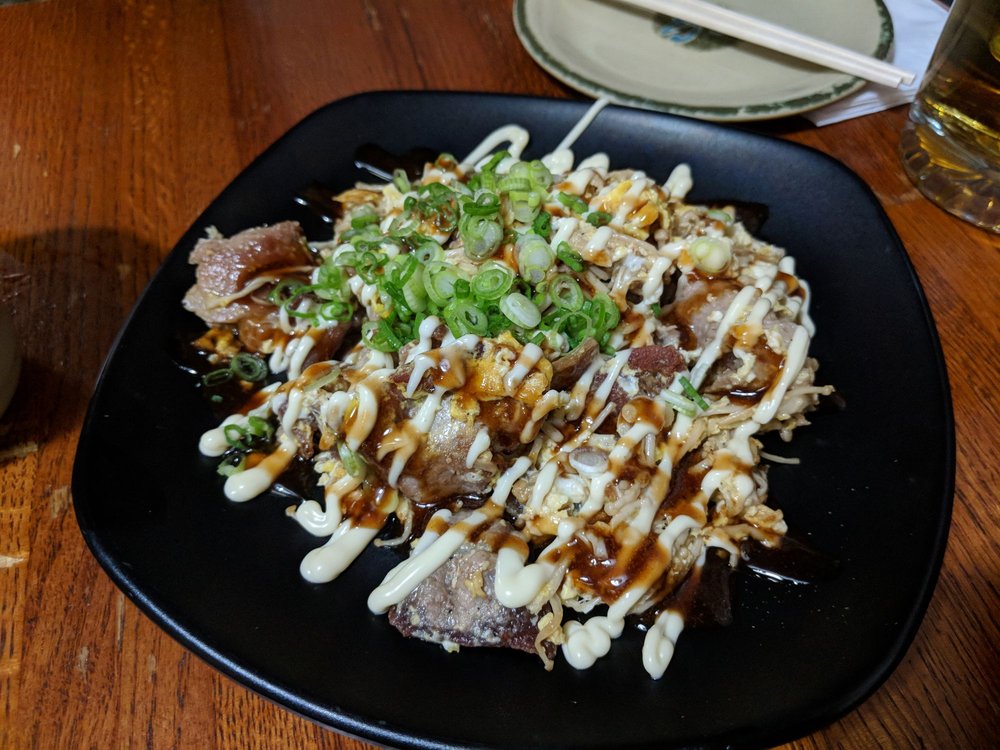 Grilled dish topped with mayonnaise, sweet sauce and green onion