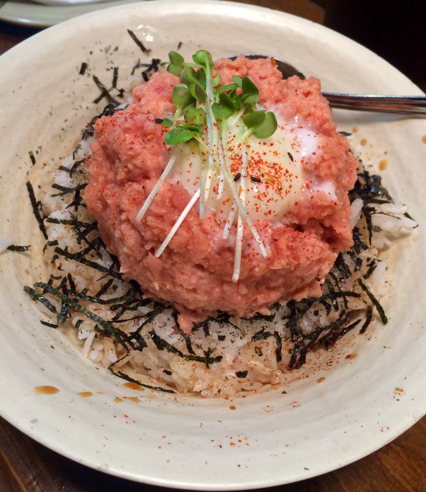 Minced tuna over rice with seaweed and a raw egg yolk